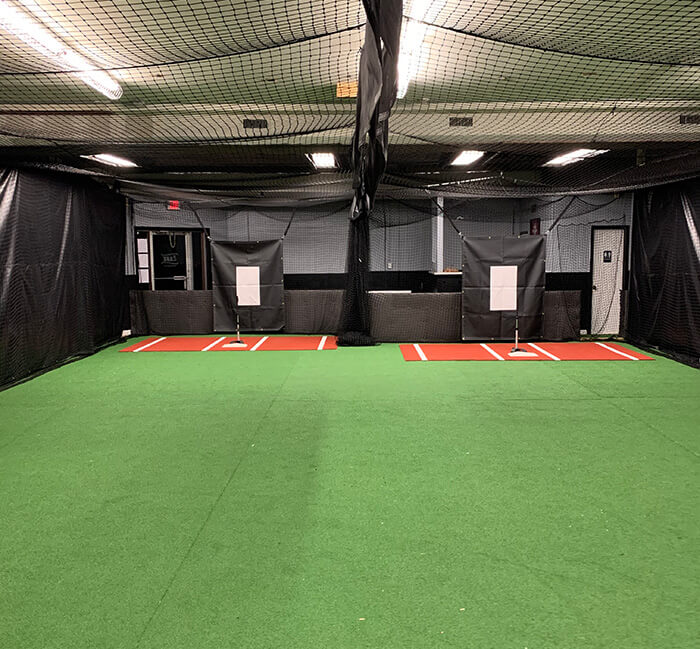 two batting cage tunnels with turf, tees and backstop